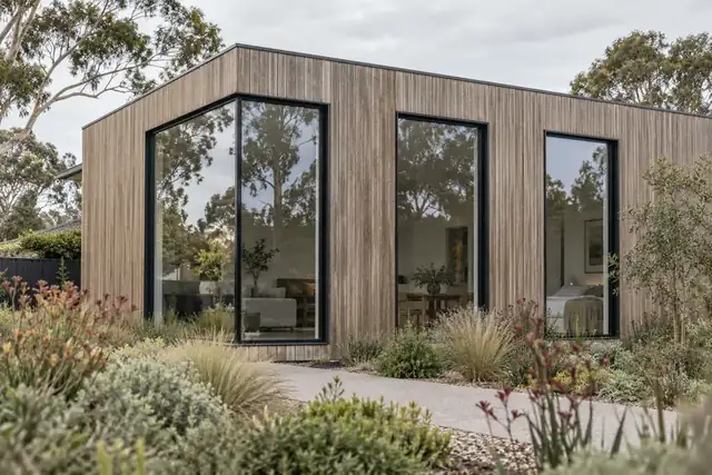 Timber-clad house with black aluminium windows